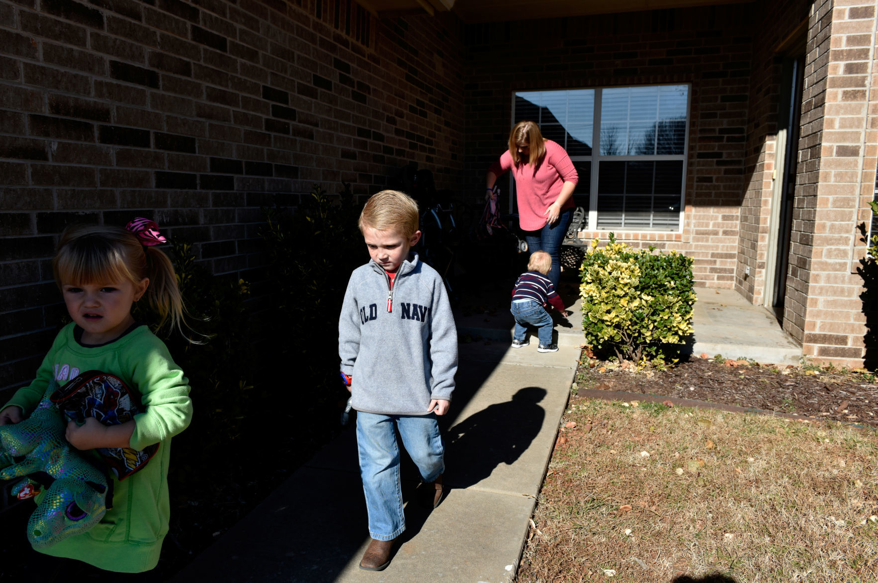Stephanie Oakley follows her children as they leave for her son's chemotherapy treatment at their home in Oklahoma City